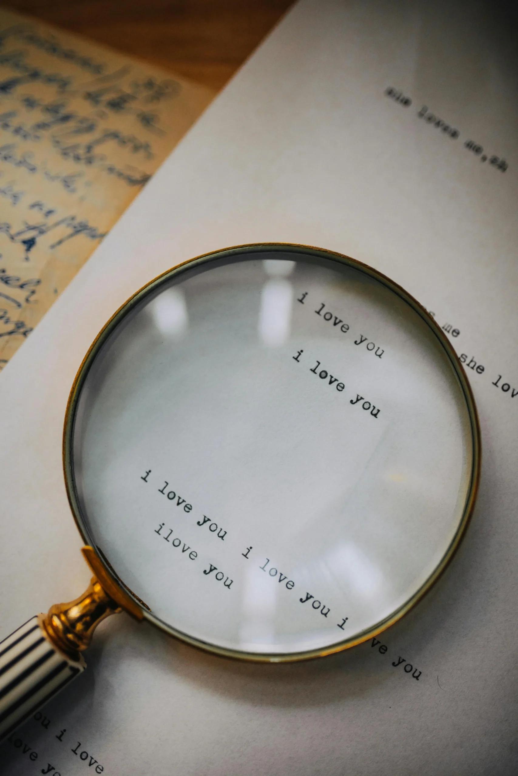Magnifying glass enlarging the words “I love you” on a page, symbolizing the close examination of love and relationships that occurs in relationship OCD.