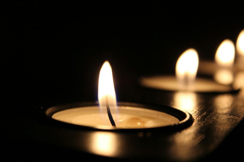 Two lit candles, evoking warmth, reflection, and calm in the midst of relationship anxiety and relationship OCD.